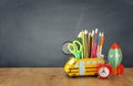 Education and back to school concept. pencils stand as bus and cardboard rocket over wooden desk infront of classroom blackboard Royalty Free Stock Photo