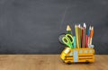 Education and back to school concept. pencils stand as bus over wooden desk infront of classroom blackboard Royalty Free Stock Photo