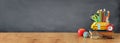 Education and back to school concept. pencils stand as bus over wooden desk infront of classroom blackboard Royalty Free Stock Photo