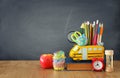 Education and back to school concept. pencils stand as bus over wooden desk infront of classroom blackboard Royalty Free Stock Photo