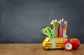 Education and back to school concept. pencils stand as bus over wooden desk infront of classroom blackboard Royalty Free Stock Photo