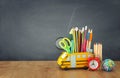 Education and back to school concept. pencils stand as bus over wooden desk infront of classroom blackboard Royalty Free Stock Photo