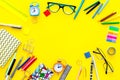 Education background, frame. School, student, office supplies. Stationery, glasses, alarm clock, notebook on yellow Royalty Free Stock Photo