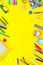 Education background, frame. School, student, office supplies. Stationery, glasses, alarm clock, notebook on yellow Royalty Free Stock Photo