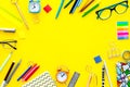 Education background, frame. School, student, office supplies. Stationery, glasses, alarm clock, notebook on yellow Royalty Free Stock Photo