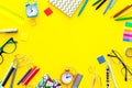 Education background, mockup. School, student, office supplies. Stationery, glasses, alarm clock, notebook on yellow Royalty Free Stock Photo