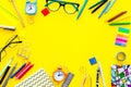 Education background, mockup. School, student, office supplies. Stationery, glasses, alarm clock, notebook on yellow Royalty Free Stock Photo