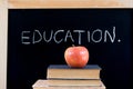 EDUCATION on chalkboard with apple & books Royalty Free Stock Photo