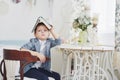 Education, childhood, people, homework and school concept - bored student boy reading book or textbook at home Royalty Free Stock Photo