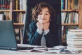 Schoolboy read books, Cute boy reading book in library Royalty Free Stock Photo