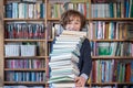 Schoolboy read books, Cute boy reading book in library Royalty Free Stock Photo