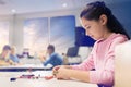 Happy girl building robot at robotics school