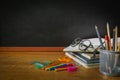 Education, Concept Back To School. front view of School Supplies chalkboard on wooden table with books, glasses, color, Pencil,