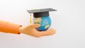 Education concept. 3d of the world wearing graduation hat on hand on white background. Modern flat design isometric concept of
