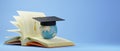 Education concept. 3d of The world wears a graduate hat on the book on blue background. Modern flat design isometric concept of Royalty Free Stock Photo