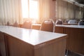 Education concept: Empty college or university classroom with wooden tables and chairs in row without student or teacher in the ro Royalty Free Stock Photo