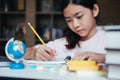 Girl reading and writing and do homework in library Royalty Free Stock Photo