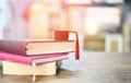 Education concept with graduation cap on a book on the wooden table