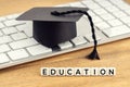Education concept. Graduation cap on computer keyboard Royalty Free Stock Photo