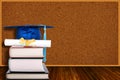 Education Concept With Graduation Hat and Diploma on Books and Cork board Background Royalty Free Stock Photo