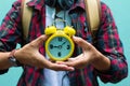 Education Concept. Man in Scottish shirt.Holding clock Waiting studying,learning ,Tutor books with friends.On green background. Royalty Free Stock Photo