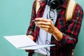 Education Concept. Man in Scottish shirt.Holding green notebook Waiting studying,learning