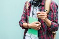 Education Concept. Man in Scottish shirt.Holding green notebook Waiting studying,learning ,Tutor books with friends.On green backg