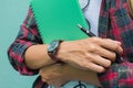 Education Concept. Man in Scottish shirt.Holding green notebook Waiting studying,learning