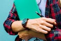 Education Concept. Man in Scottish shirt.Holding green notebook Waiting studying,learning