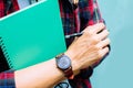 Education Concept. Man in Scottish shirt.Holding green notebook Waiting studying,learning