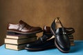 Education concept with mens leather shoes and stack of book Royalty Free Stock Photo