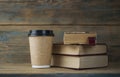 Education concept. Online education course. Books and disposable cup on wooden surface Royalty Free Stock Photo