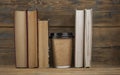 Education concept. Online education course. Books and disposable cup on wooden surface Royalty Free Stock Photo