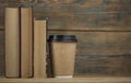 Education concept. Online education course. Books and disposable cup on wooden surface Royalty Free Stock Photo