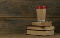 Education concept. Online education course. Books and disposable cup on wooden surface Royalty Free Stock Photo