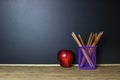 Education concept. Pencil and red apple on wood table. Royalty Free Stock Photo