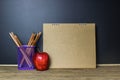 Education concept. Pencil and red apple on wood table.