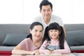 Education concept.Portrait enjoy happy smiling love asian family father and mother with little asian girl learning and writing in Royalty Free Stock Photo