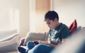 Education concept,School kid using mobile phone readying story from internet,Boy studying online learning at home,Child using cell Royalty Free Stock Photo