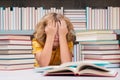 Education Concept. Schoolboy reading book in library. Kids development, learn to read. Pupil reading books in a school Royalty Free Stock Photo