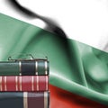 Education concept - Stack of books and reading glasses against National flag of Bulgaria Royalty Free Stock Photo