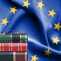 Education concept - Stack of books and reading glasses against National flag of European Union Royalty Free Stock Photo