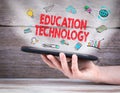 Education concept. Tablet computer in the hand. Old wooden background Royalty Free Stock Photo