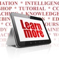 Education concept: Tablet Computer with Learn More on display Royalty Free Stock Photo