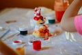 Education concept: toy animal figures are being painted with colorful paints by children. Royalty Free Stock Photo