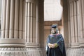 Young Malaysian woman holding a degree certificate while smiling on her graduation day Royalty Free Stock Photo