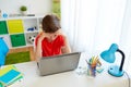 Tired student boy with laptop computer at home Royalty Free Stock Photo