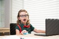 Education and distance learning for kids, homeschooling. School child watching online education class on the internet at