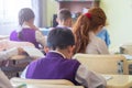 Education, elementary school, group of school kids sitting and l