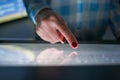 Woman using interactive touchscreen display at modern museum or exhibition